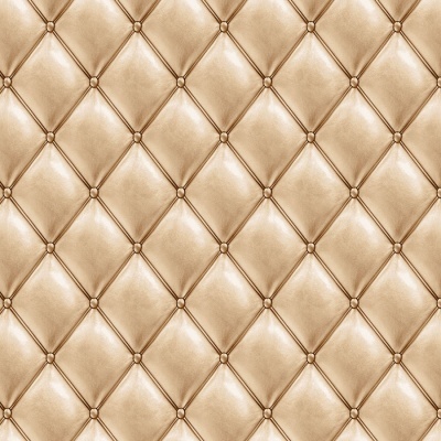 Superfície estofada em couro sintético bege dourado com padrão de losangos e botões