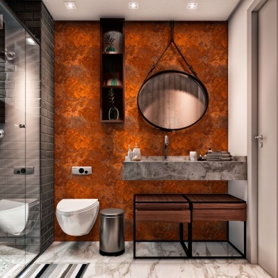 Casa de banho com parede laranja, bancada de mármore, espelho redondo e sanitário branco