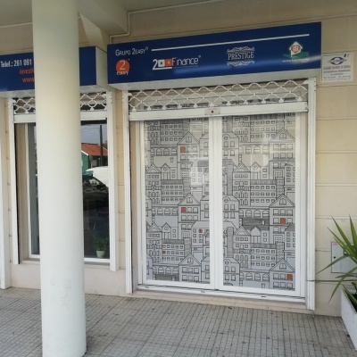Vitrine com película adesiva ilustrada cinza e branca em porta de vidro