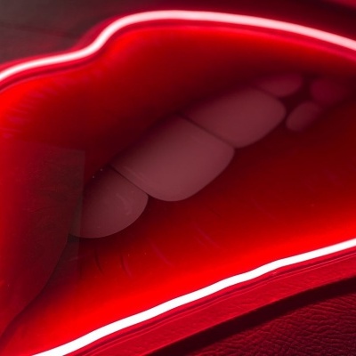 Decoração em forma de boca com luzes neon vermelhas
