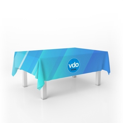 Toalha de mesa azul com logotipo vdo STOILS sobre mesa branca