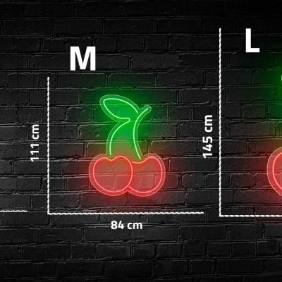 Luzes de néon em forma de cerejas em três tamanhos diferentes contra parede de tijolos pretos