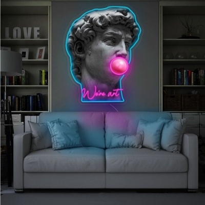 Escultura clássica com bolha de chiclete e iluminação néon 'We’re art' numa sala de estar moderna.