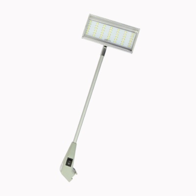 Luminária LED portátil cinzenta com painel retangular e botão de ligar na base.