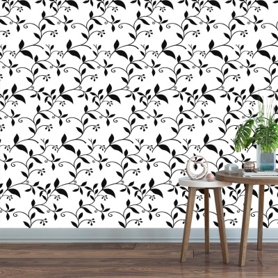 Papel de parede branco com padrão de folhas pretas, e mesa de madeira com plantas