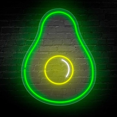 Neon em forma de abacate em parede de tijolos