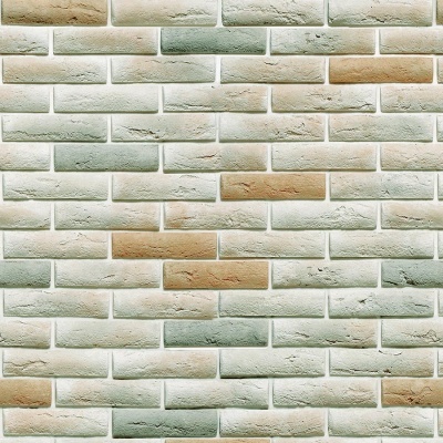 Parede com azulejos tipo tijolo em tons claros e textura irregular.