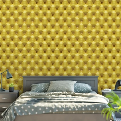 Quarto com parede amarelo dourado acolchoada, cama cinza, almofadas cinza e padrão branco, mesas laterais com candeeiros.