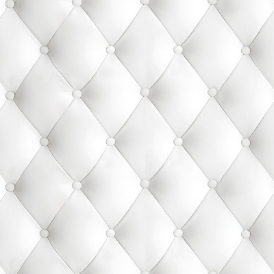 Superfície estofada branca com padrão de losangos e botões.