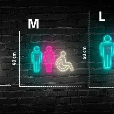 Sinais de neon com figuras humanas e cadeira de rodas em três tamanhos contra parede preta