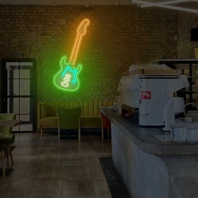Interior de café com máquinas de café, mesas, cadeiras e luz de néon em forma de guitarra