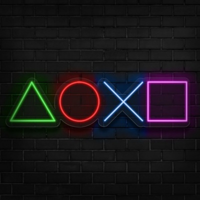 Neon lights verdes, vermelhas, azuis e rosas em formas geométricas numa parede de tijolos preta