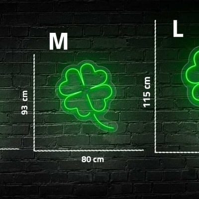 Sinais de néon verdes em forma de trevo de quatro folhas com tamanhos S, M e L