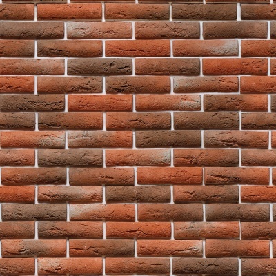 Parede de tijolos vermelhos e castanhos com junta branca