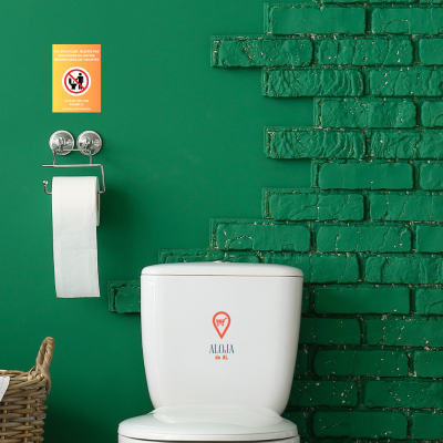 Casa de banho verde com sanita branca e suporte de papel higiénico