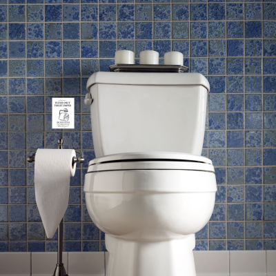 Sanita branca com tampa preta e suporte de papel higiénico em azulejos azuis