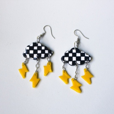 Brincos em forma de nuvem preto e branco com raios amarelos pendurados