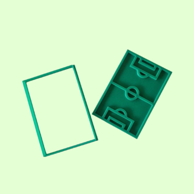 Duas caixas verdes de plástico com relevo de campo de futebol em fundo verde claro