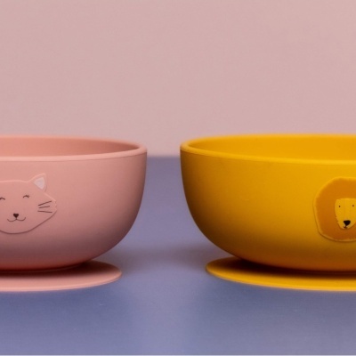 Dois pratos fundos de silicone rosa e amarelo com desenhos de gato e leão