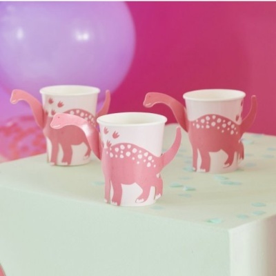 Três copos de papel com suportes rosa em forma de dinossauro