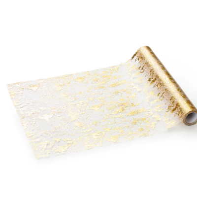 Rolo de tecido decorativo transparente com padrão dourado irregular.