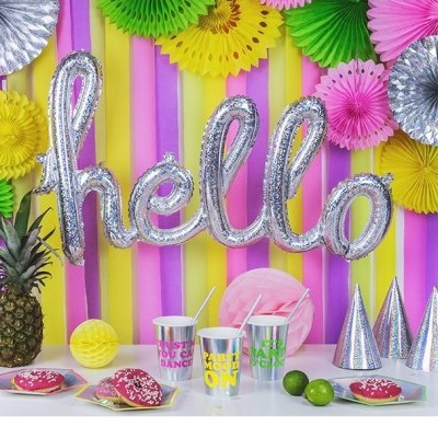 Decoração de festa colorida com balão 'hello', frutas, copos e chapéus prateados