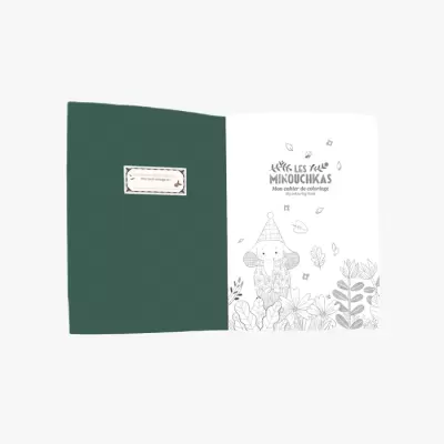 Livro de colorir aberto com capa verde escura e página com título e ilustração de elefante e flores em preto e branco