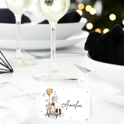 Cartão de lugar branco com decoração dourada e texto Amélia numa mesa posta elegante