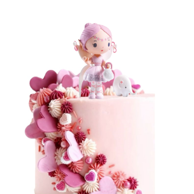 Bolo rosa claro com enfeites em rosa e branco e figura de topo de bolo de personagem cor-de-rosa