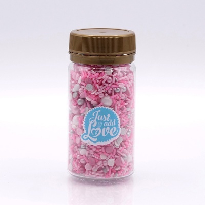 Frasco com confeitos para bolos rosa e branco com rótulo 'Just add Love'