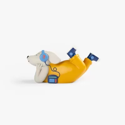 Figura decorativa de cão com roupa amarela e botas azuis a ouvir música