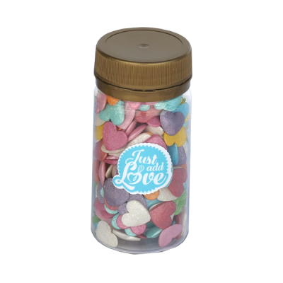 Frasco com confeitos coloridos em forma de coração e rótulo 'Just add Love'.