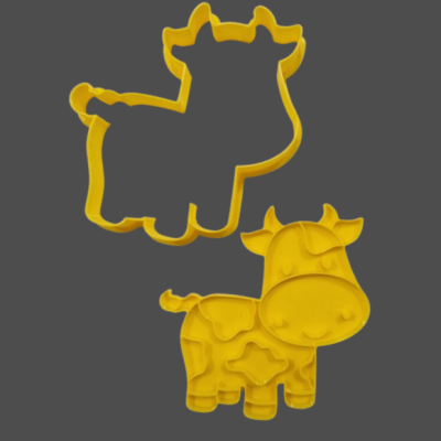 Formas cortadoras amarelas em forma de vaca em fundo cinzento