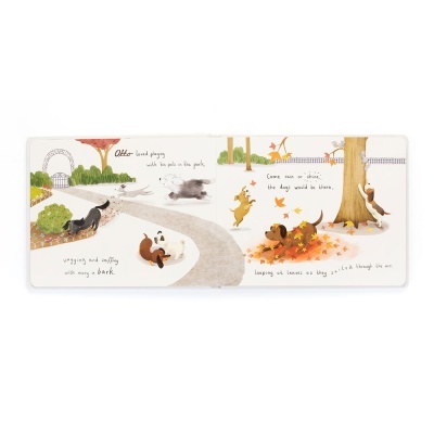 Livro infantil aberto com ilustrações de cães no parque e texto em inglês