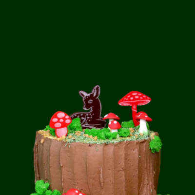 Bolo decorado com tema de floresta, cogumelos e coelho de chocolate.