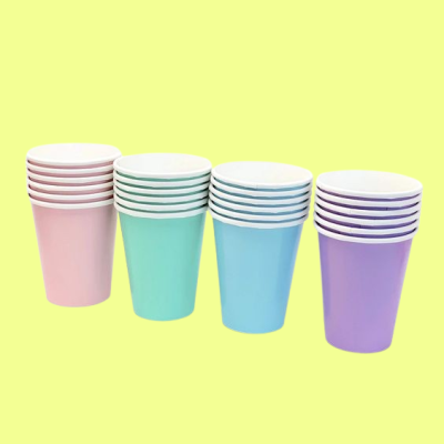 Quatro pilhas de copos coloridos em tons pastel sobre fundo amarelo