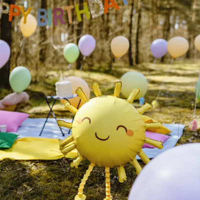 Balão sol sorridente amarelo com decoração de festa ao ar livre