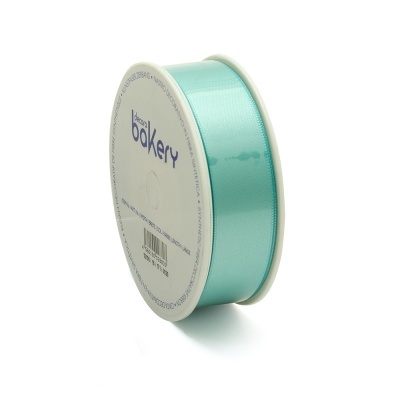 Rolo de fita azul turquesa acetinada em suporte branco com texto bakery