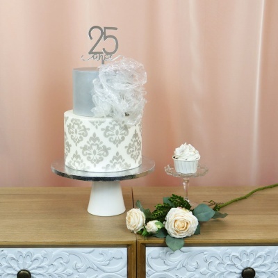 Bolo decorado de 25 anos com cupcake e ramo de rosas em móvel
