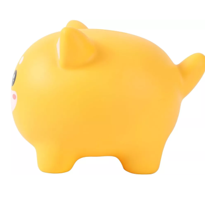 Figura amarela de animal de borracha visto de lado