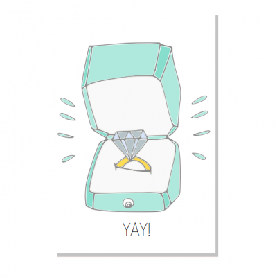 Anel de diamante num estojo azul aberto com o texto YAY!