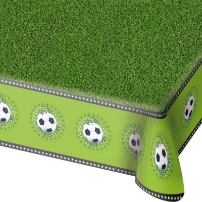 Toalha de mesa com padrão de relva e bolas de futebol decorativas.