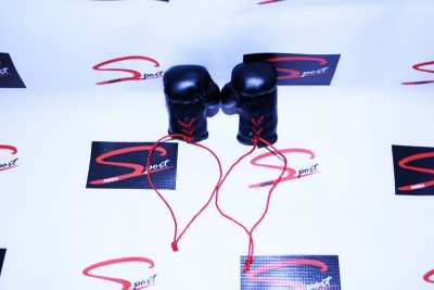 Luvas de boxe pretas com cordões vermelhos sobre fundo branco com logotipos Sspot.