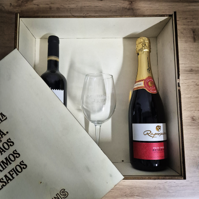 Caixa de presente com duas garrafas de vinho e uma taça de vidro
