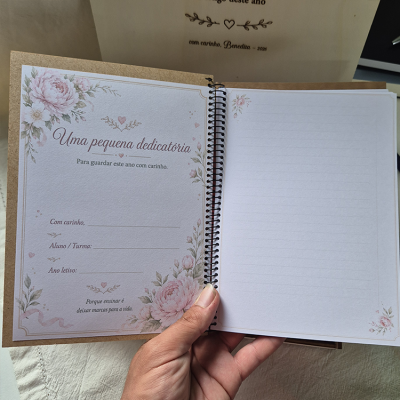 Caderno espiral com página decorada e campos para dedicatória e página pautada com flores