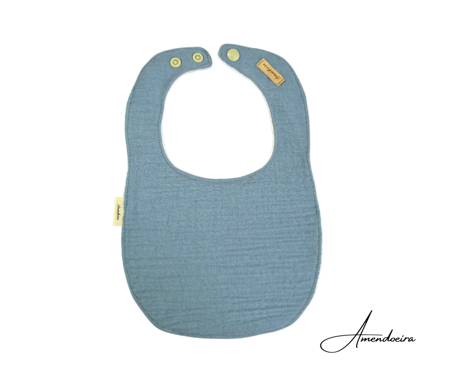 Babete Musselina - Azul ganga Babete impermeável e com tecido 100% algodão para bebé