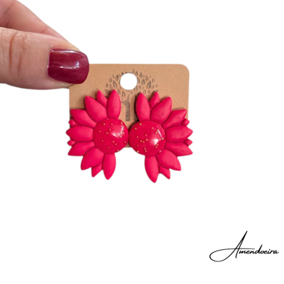 Brincos vermelhos em forma de flor em cartão castanho