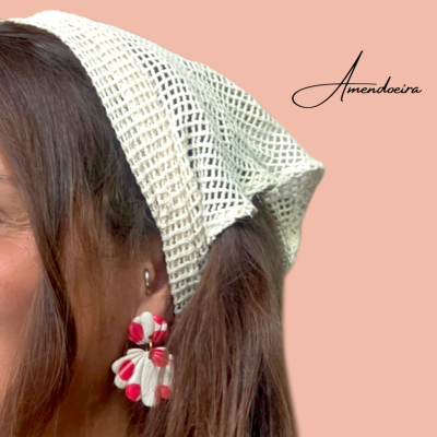 Mulher com lenço branco e brincos florais brancos e vermelhos