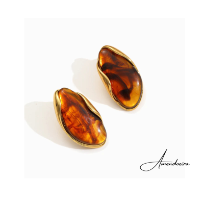 Brincos com pedras âmbar e metal dourado em fundo branco