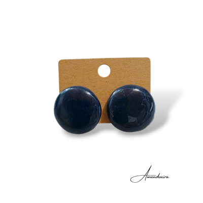 Par de botões redondos azuis escuros num cartão castanho com furo